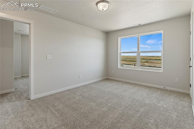 9803 Blaurock Dr, Fountain, CO 80817 - carpeted spare room with baseboards, a textured ceiling, and visible vents
