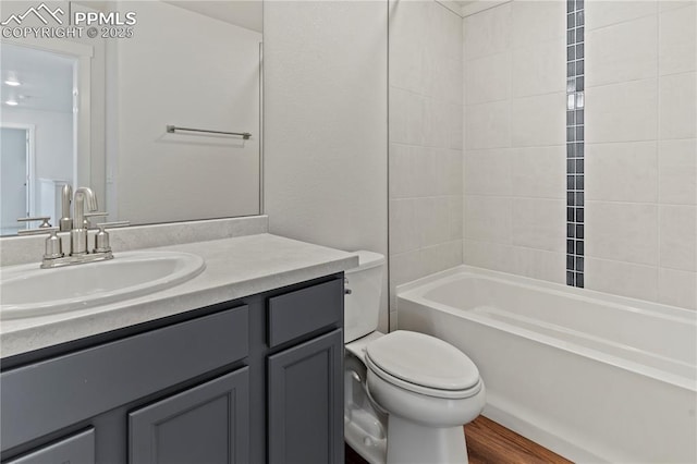 9803 Blaurock Dr, Fountain, CO 80817 - full bath with toilet,  shower combination, wood finished floors, and vanity