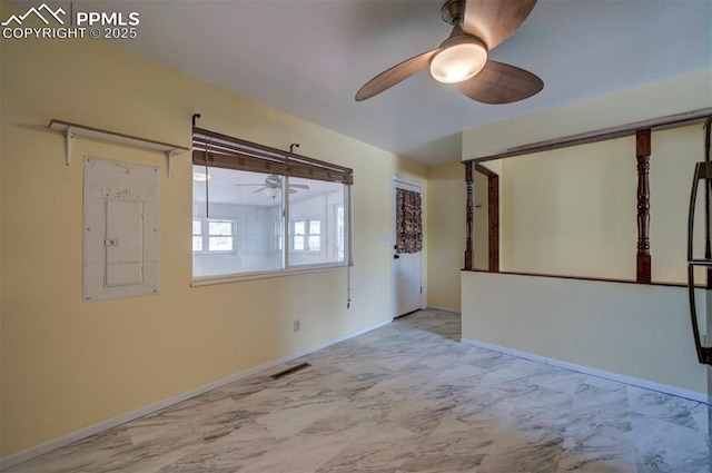 spare room with visible vents, a ceiling fan, marble finish floor, and baseboards