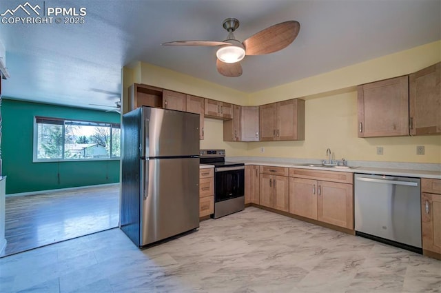 kitchen featuring a sink, light countertops, a ceiling fan, and stainless steel appliances