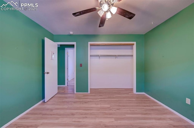 unfurnished bedroom featuring a closet, baseboards, and wood finished floors