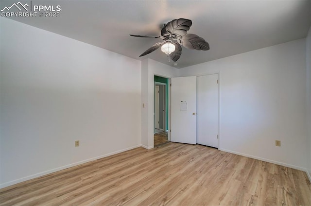 unfurnished bedroom with baseboards, a ceiling fan, and light wood-style flooring