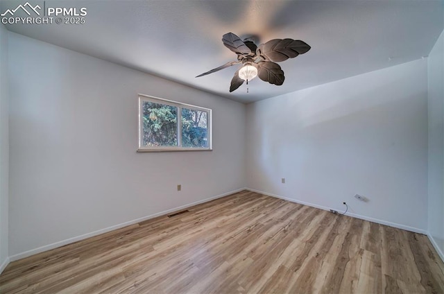 empty room with a ceiling fan, baseboards, visible vents, and light wood-type flooring