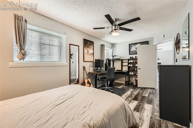 bedroom featuring a textured ceiling, a ceiling fan, and wood finished floors