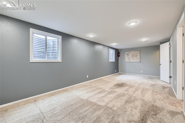 interior space featuring carpet, multiple windows, and baseboards