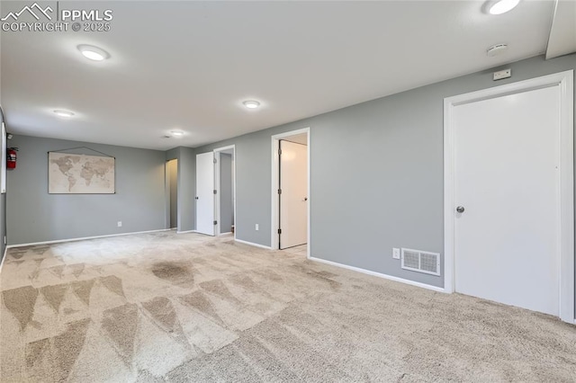 below grade area featuring carpet, baseboards, and visible vents