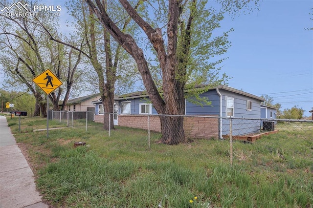 view of side of home featuring fence