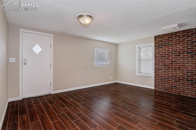 508 E Ohio Ave, Fountain, CO 80817 - entryway with healthy amount of natural light, wood finished floors, and brick wall