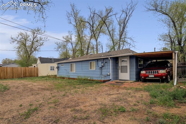 view of front of home with fence and an attached carport