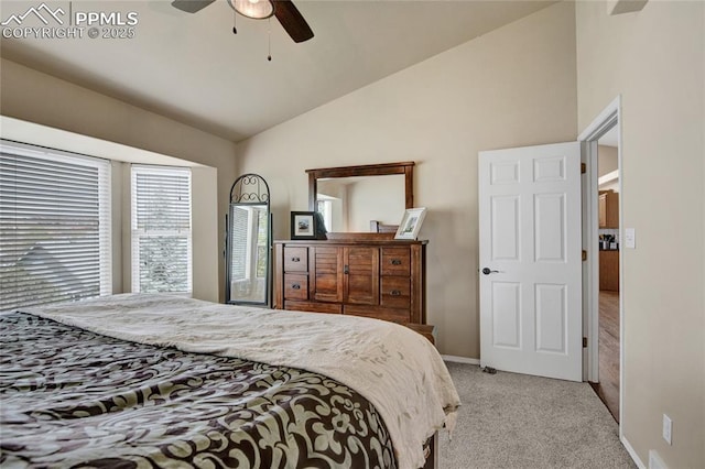 bedroom featuring a ceiling fan, baseboards, light carpet, and lofted ceiling