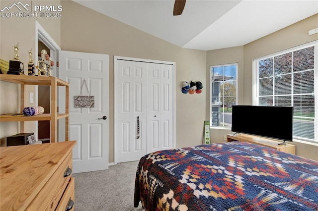 bedroom with a closet, carpet, ceiling fan, and vaulted ceiling