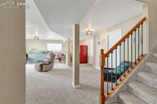 interior space with baseboards, carpet flooring, and visible vents
