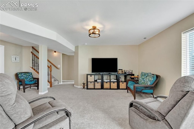 living room featuring stairway, baseboards, and carpet flooring