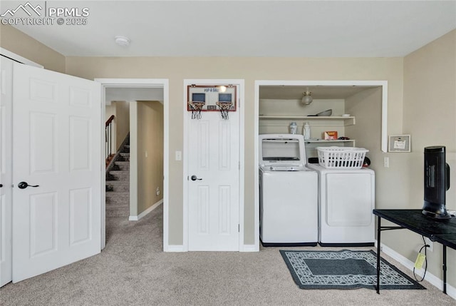 washroom featuring carpet flooring, laundry area, baseboards, and washer and clothes dryer