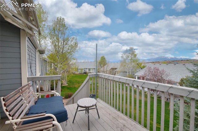 wooden deck with a residential view and a yard