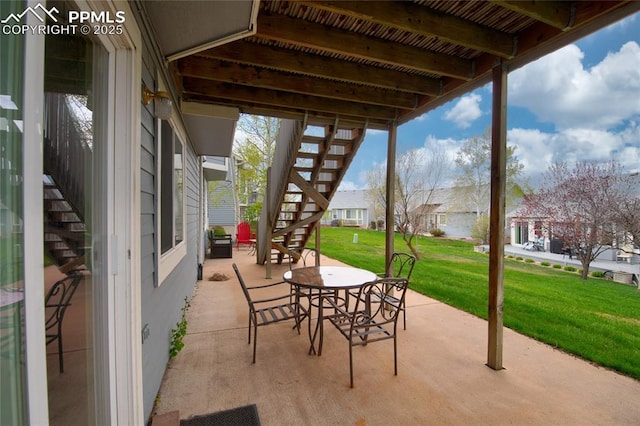 view of patio / terrace featuring stairway and a residential view