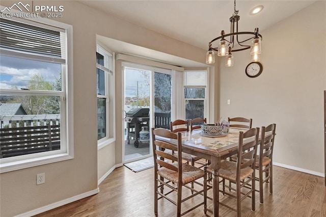 dining room with recessed lighting, baseboards, a chandelier, and wood finished floors