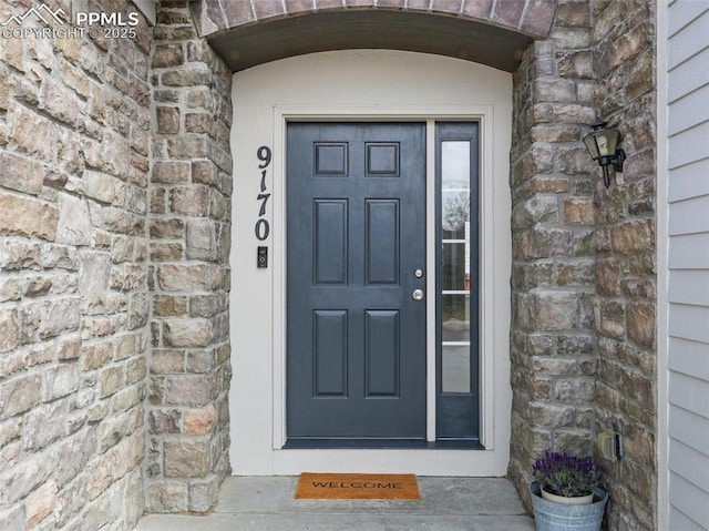 entrance to property featuring stone siding