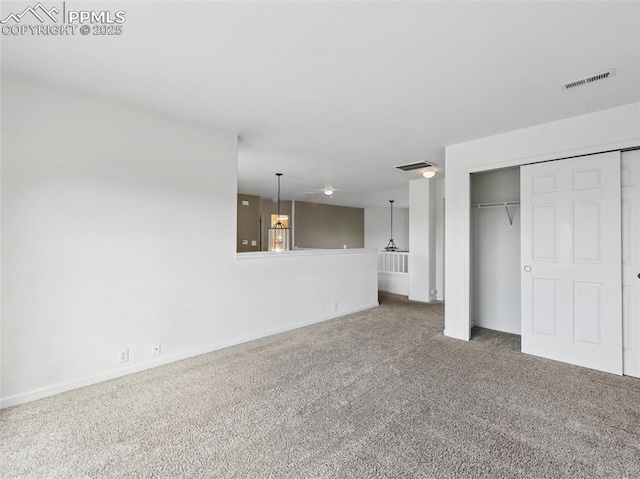 interior space featuring visible vents, baseboards, carpet floors, and a closet