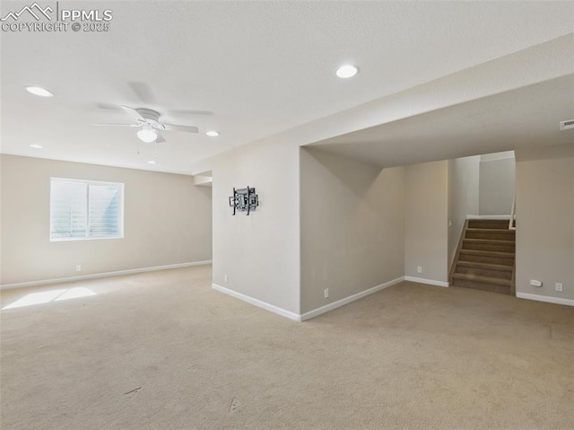 below grade area featuring stairs, recessed lighting, baseboards, and light carpet
