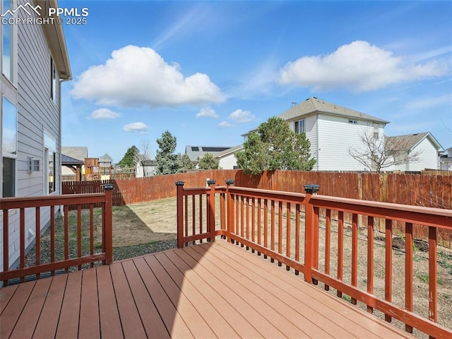 deck featuring a fenced backyard and a residential view