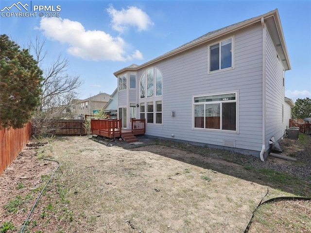 back of house with cooling unit, a wooden deck, and a fenced backyard