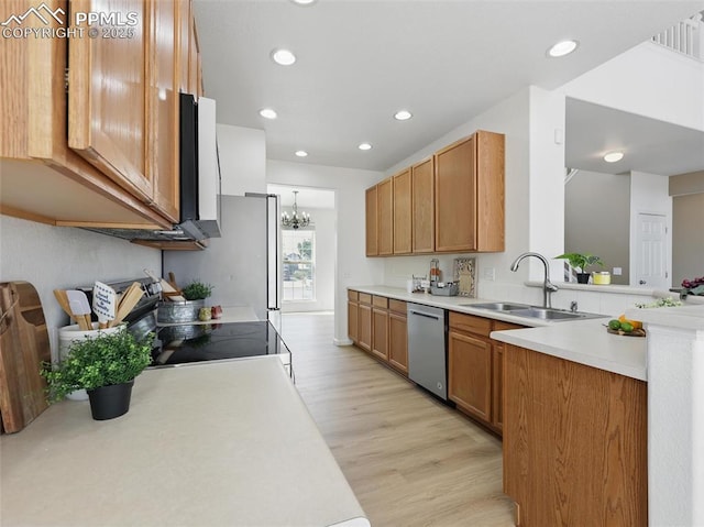 kitchen featuring a sink, dishwasher, light countertops, recessed lighting, and light wood-type flooring