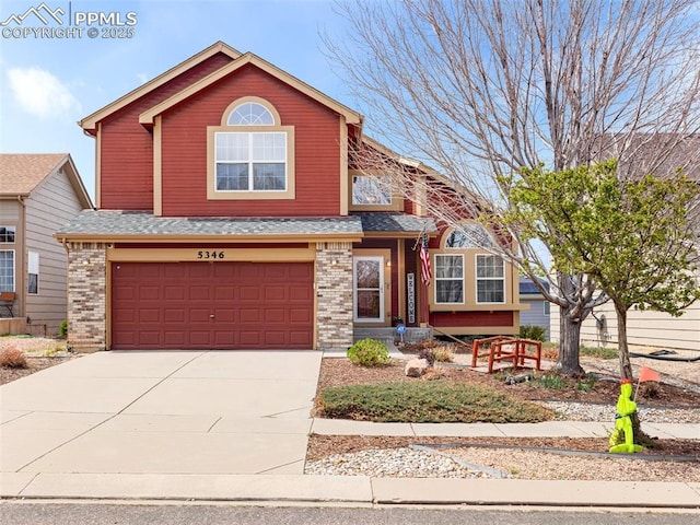 5346 Gentle Wind Rd, Colorado Springs, CO 80922 - view of front of house featuring an attached garage, brick siding, driveway, and a shingled roof