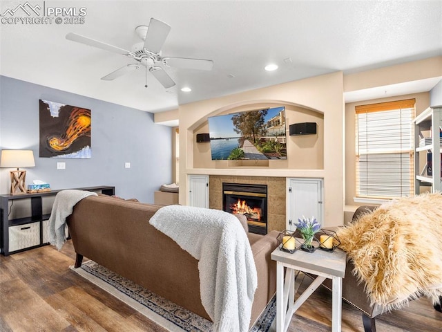 5346 Gentle Wind Rd, Colorado Springs, CO 80922 - living area with wood finished floors, a tiled fireplace, recessed lighting, and a ceiling fan