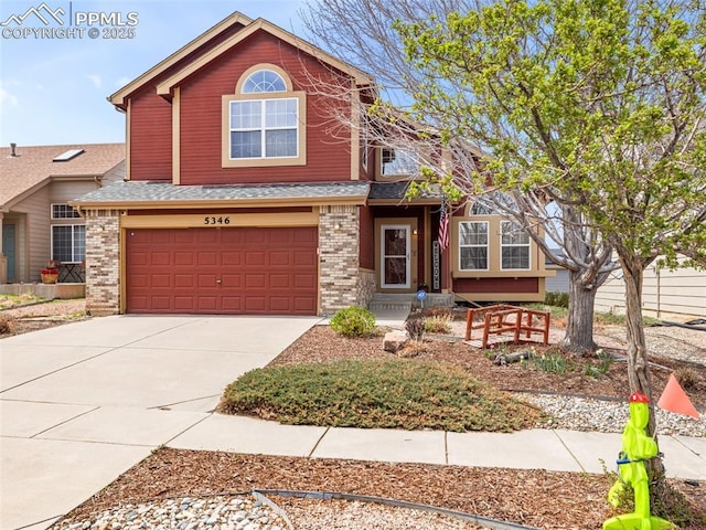 5346 Gentle Wind Rd, Colorado Springs, CO 80922 - view of front of house featuring brick siding, an attached garage, driveway, and roof with shingles
