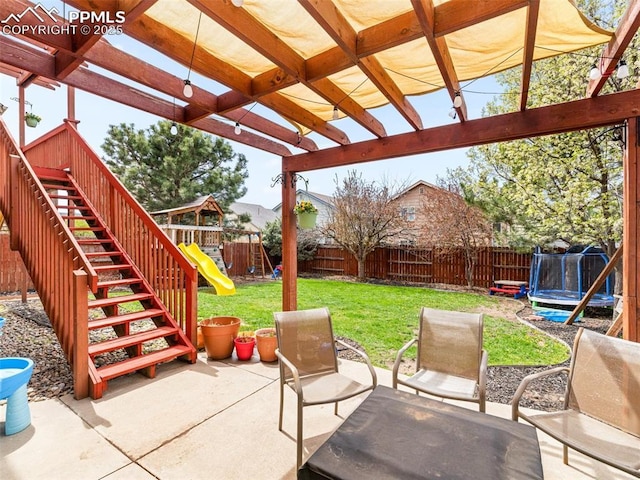 5346 Gentle Wind Rd, Colorado Springs, CO 80922 - view of patio / terrace with a trampoline, a playground, stairway, and a pergola