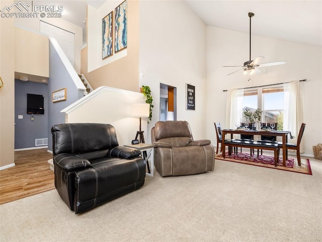 5346 Gentle Wind Rd, Colorado Springs, CO 80922 - living room with high vaulted ceiling, a ceiling fan, carpet floors, baseboards, and stairs