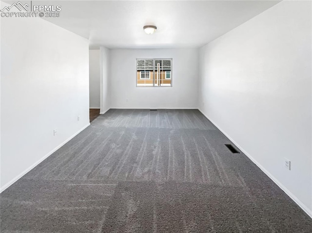 carpeted empty room featuring baseboards and visible vents