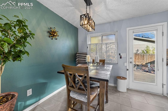 1065 N 19th St, Colorado Springs, CO 80904 - tiled dining room featuring baseboards, a textured ceiling, and a notable chandelier