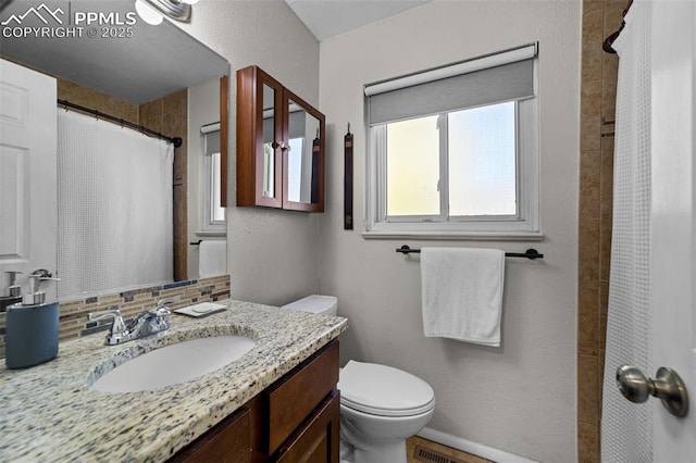1065 N 19th St, Colorado Springs, CO 80904 - bathroom featuring vanity, curtained shower, and toilet