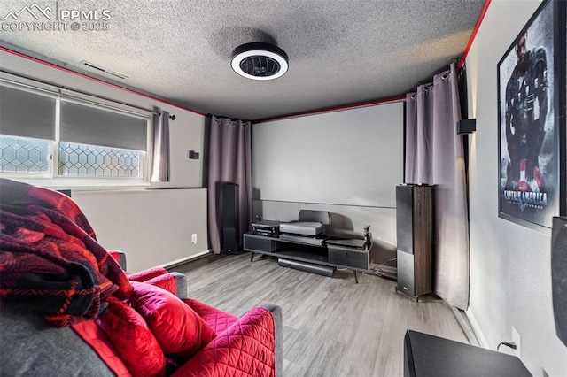 1065 N 19th St, Colorado Springs, CO 80904 - cinema room with baseboards, a textured ceiling, and wood finished floors
