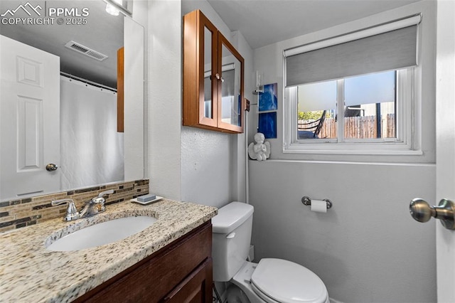 1065 N 19th St, Colorado Springs, CO 80904 - bathroom with toilet, a textured wall, visible vents, and vanity