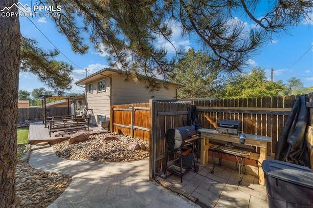 1065 N 19th St, Colorado Springs, CO 80904 - view of patio with a fenced backyard and a wooden deck
