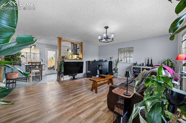 1065 N 19th St, Colorado Springs, CO 80904 - living room with a textured ceiling, an inviting chandelier, and wood finished floors
