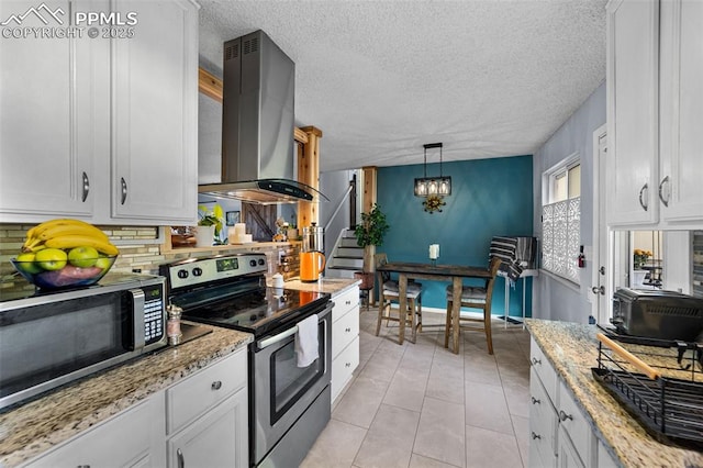 1065 N 19th St, Colorado Springs, CO 80904 - kitchen featuring island range hood, tasteful backsplash, a notable chandelier, stainless steel appliances, and white cabinetry