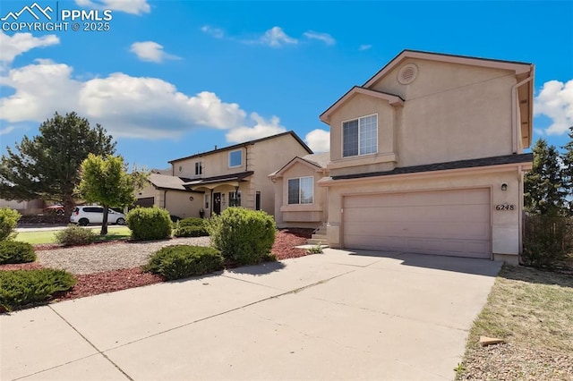 traditional-style home with a garage, stucco siding, and driveway