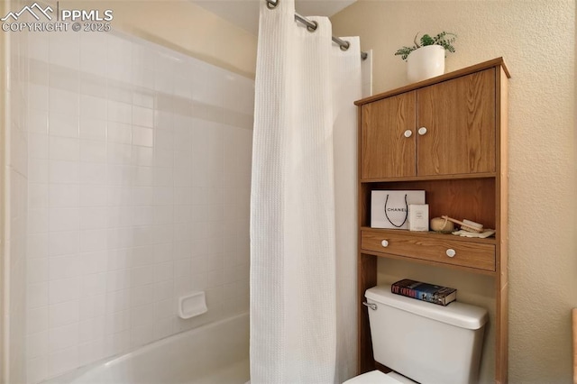 6248 Montero Cir, Colorado Springs, CO 80915 - bathroom with toilet, a textured wall, and shower / bathtub combination with curtain