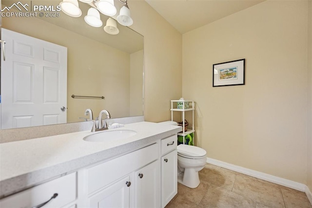 bathroom with baseboards, tile patterned floors, toilet, and vanity