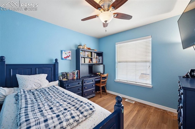 bedroom with ceiling fan, baseboards, visible vents, and wood finished floors