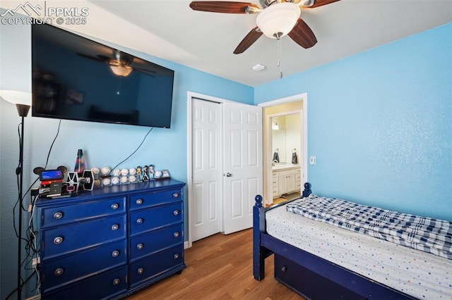 bedroom with ceiling fan, wood finished floors, and a closet