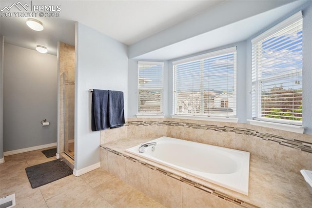 full bathroom with visible vents, tile patterned flooring, a bath, and a wealth of natural light