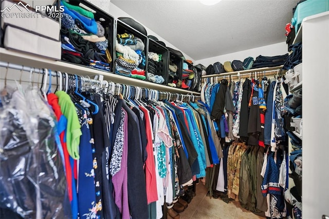 spacious closet with tile patterned flooring