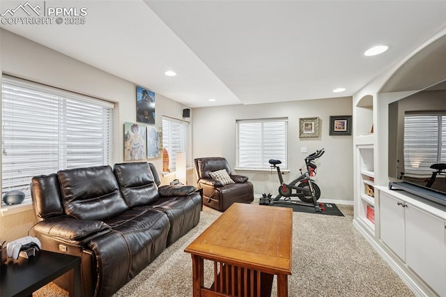 carpeted living room featuring recessed lighting, baseboards, and built in features