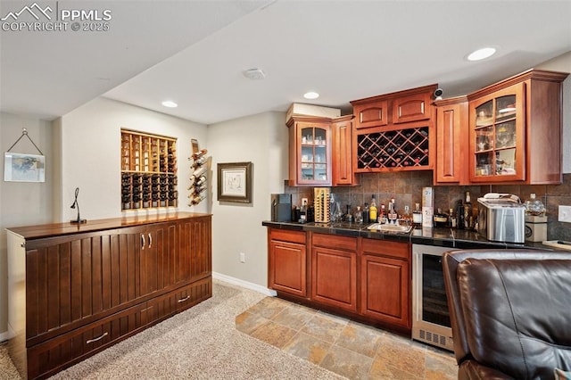 bar with decorative backsplash, wine cooler, baseboards, recessed lighting, and wet bar