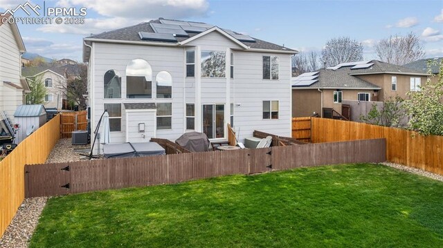 1483 W Costilla St, Colorado Springs, CO 80905 - rear view of house featuring a yard, roof mounted solar panels, and a fenced backyard